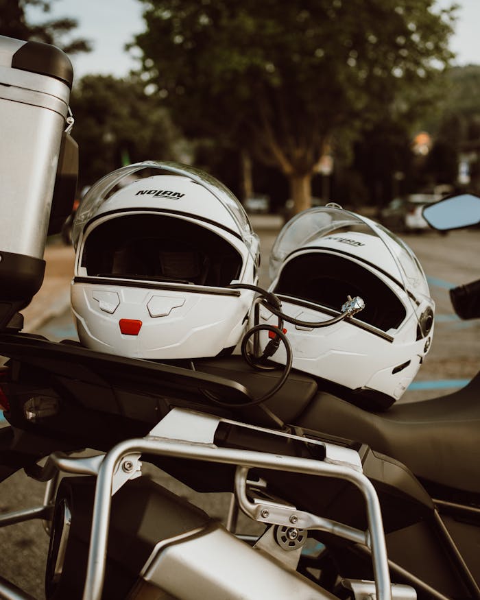 our-experience Close-up of motorcycle helmets on a bike in Stresa, Italy, perfect for travel and transportation imagery.